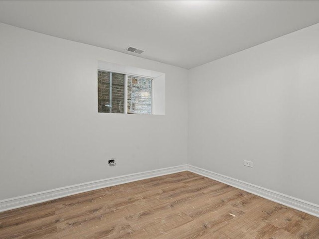 unfurnished room with hardwood / wood-style flooring