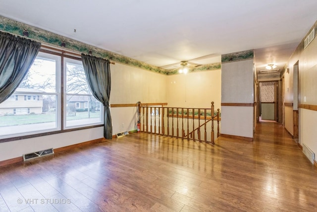 unfurnished room featuring hardwood / wood-style floors and ceiling fan