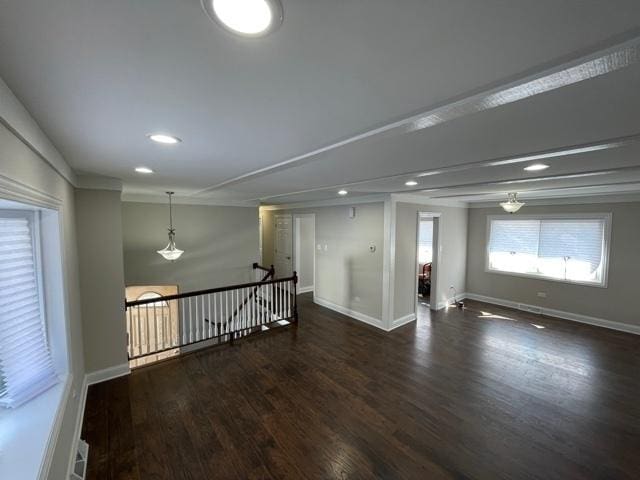 empty room with dark wood-type flooring, recessed lighting, and baseboards