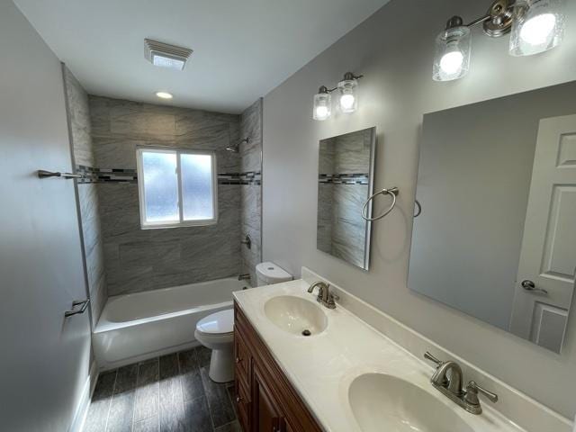 bathroom with shower / bath combination, a sink, toilet, and double vanity