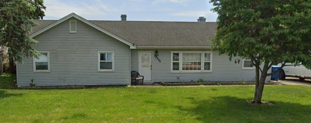 rear view of house with a lawn