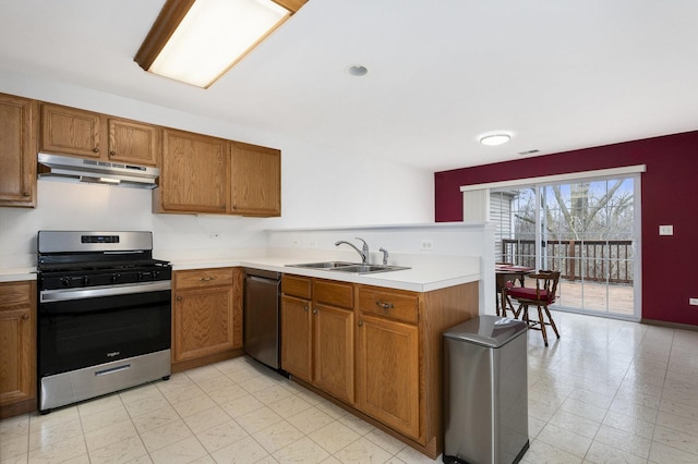 kitchen with kitchen peninsula, stainless steel appliances, and sink