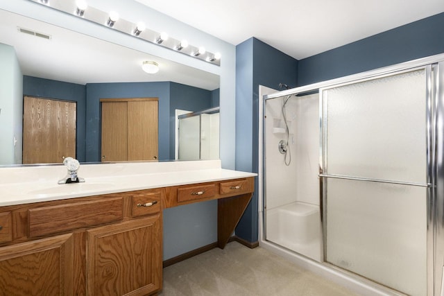 bathroom featuring vanity and a shower with door