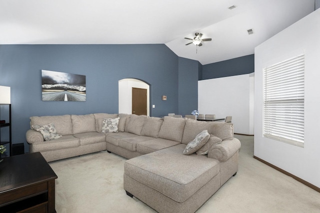 living room featuring light colored carpet, ceiling fan, and lofted ceiling