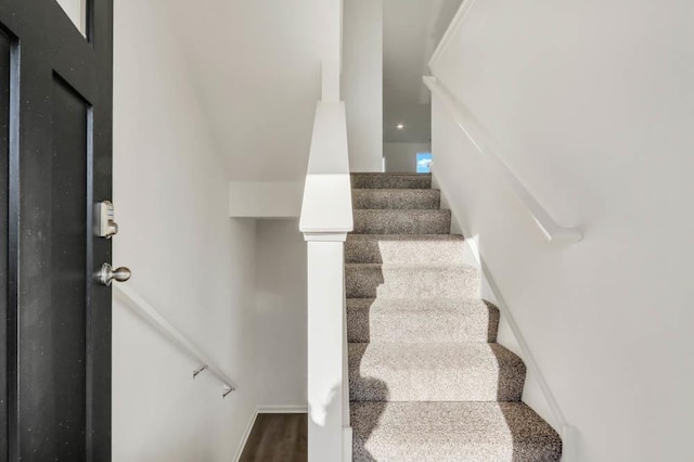 staircase featuring hardwood / wood-style floors