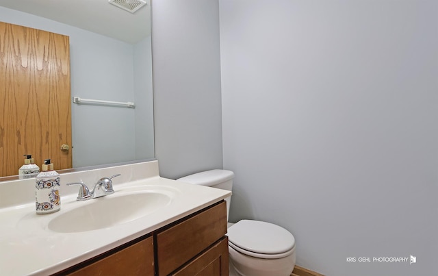 bathroom featuring vanity and toilet