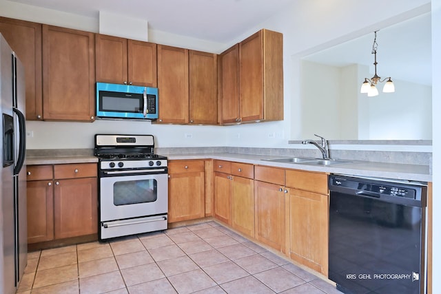 kitchen with pendant lighting, an inviting chandelier, sink, light tile patterned floors, and stainless steel appliances