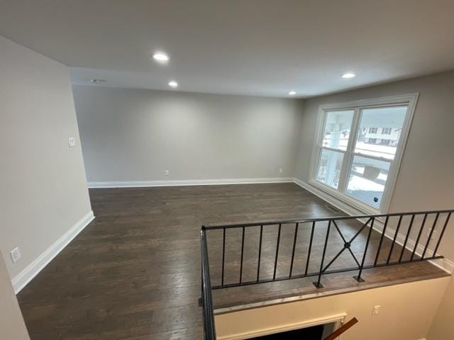 interior space with baseboards, dark wood-type flooring, and recessed lighting