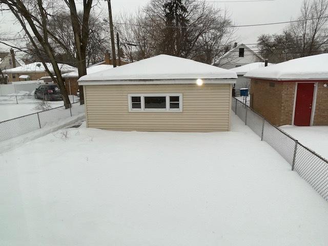 snow covered property featuring fence