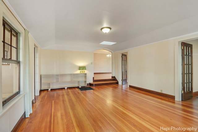 unfurnished room featuring hardwood / wood-style flooring, a chandelier, and vaulted ceiling