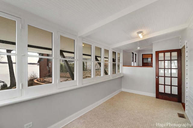 empty room featuring wood ceiling and lofted ceiling with beams