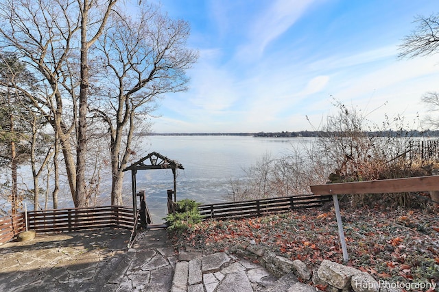 exterior space with a water view and a dock