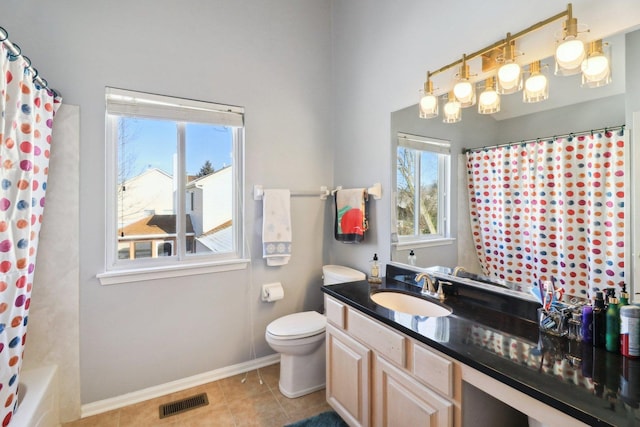 full bathroom featuring vanity, plenty of natural light, tile patterned floors, and toilet