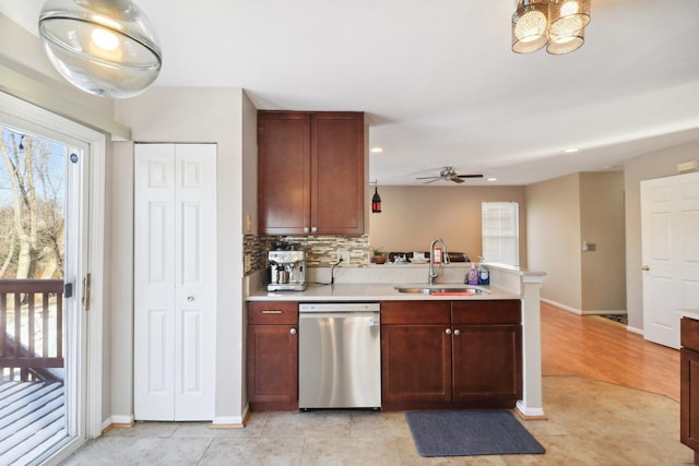 kitchen featuring light tile patterned flooring, sink, dishwasher, kitchen peninsula, and backsplash