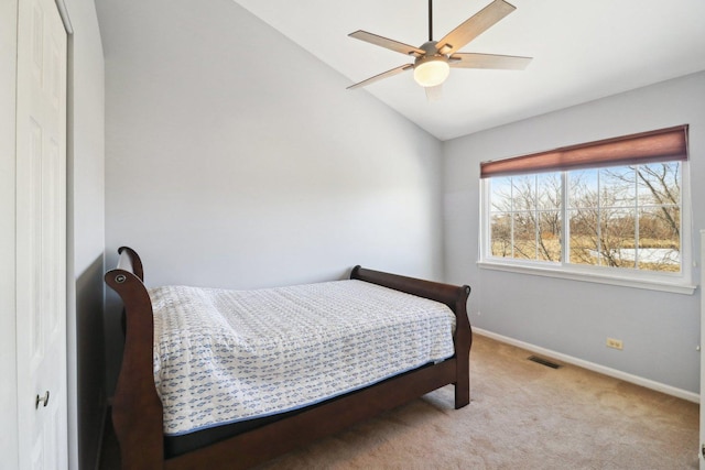 carpeted bedroom with lofted ceiling, a closet, and ceiling fan