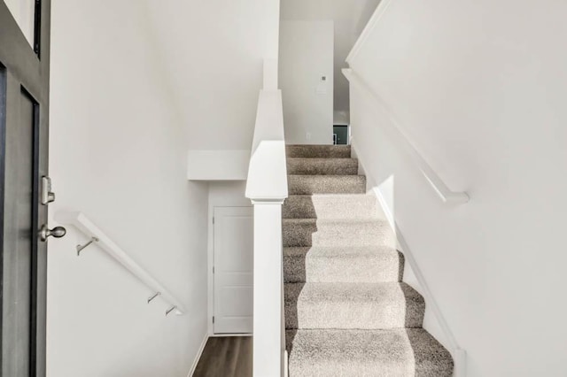 stairway with hardwood / wood-style flooring