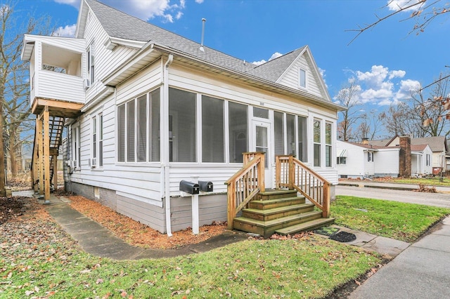 view of front of home with a sunroom