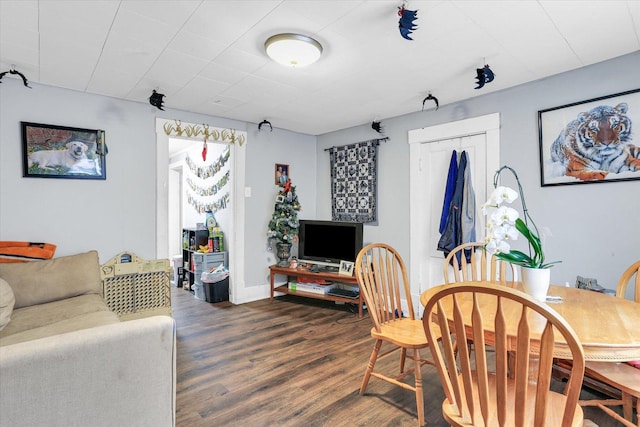 dining area featuring dark wood-type flooring