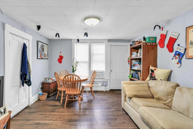 dining area with cooling unit and dark hardwood / wood-style floors