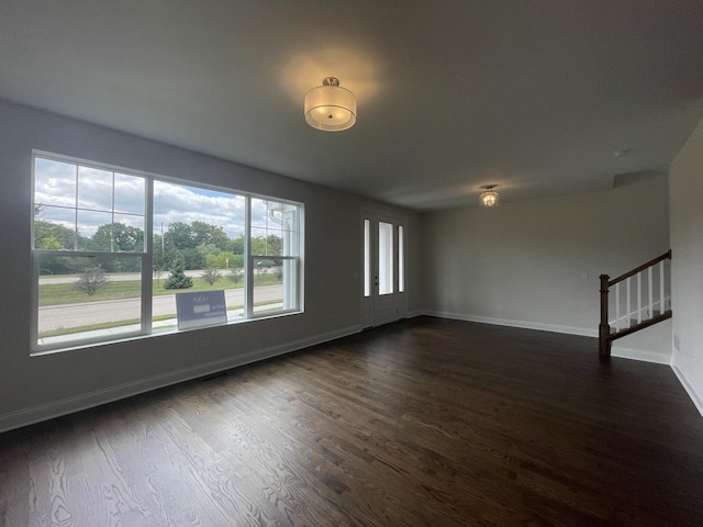 spare room with dark wood-type flooring