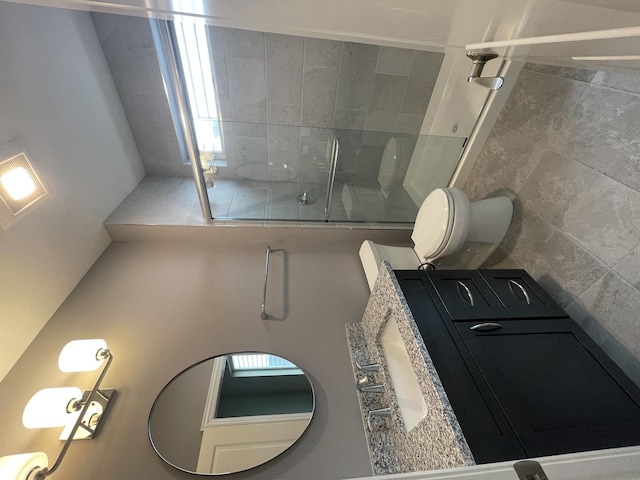 bathroom featuring toilet and a shower with door