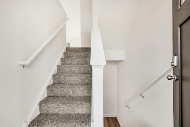 stairway with hardwood / wood-style flooring