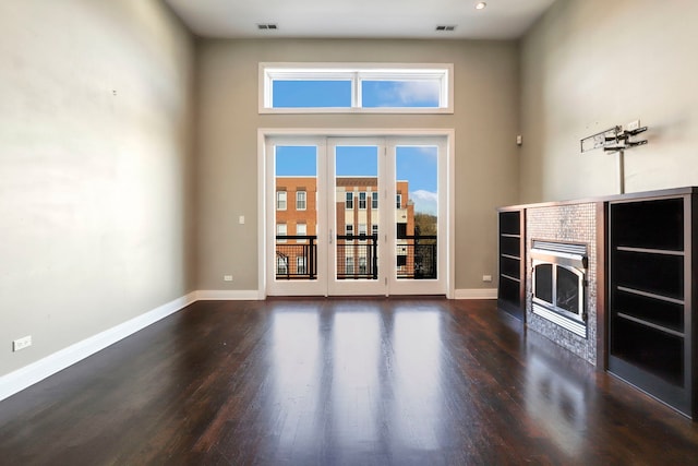 unfurnished living room featuring dark hardwood / wood-style flooring