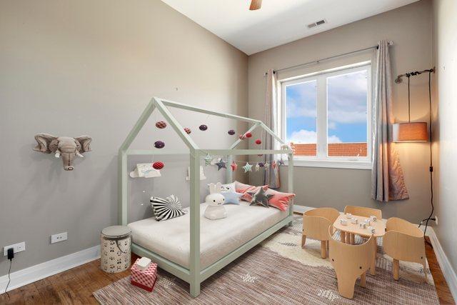 bedroom with ceiling fan and hardwood / wood-style floors