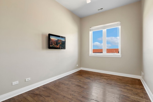 unfurnished room with dark wood-type flooring