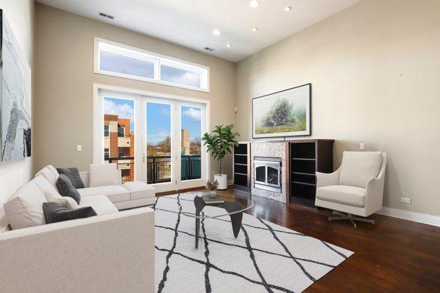 living room featuring dark hardwood / wood-style flooring and a towering ceiling