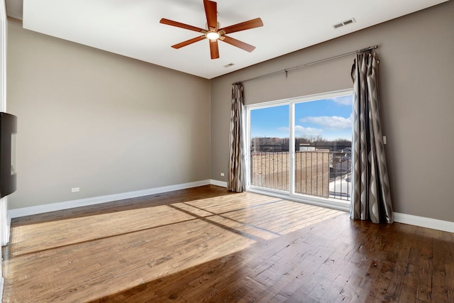 unfurnished room with ceiling fan and dark hardwood / wood-style flooring