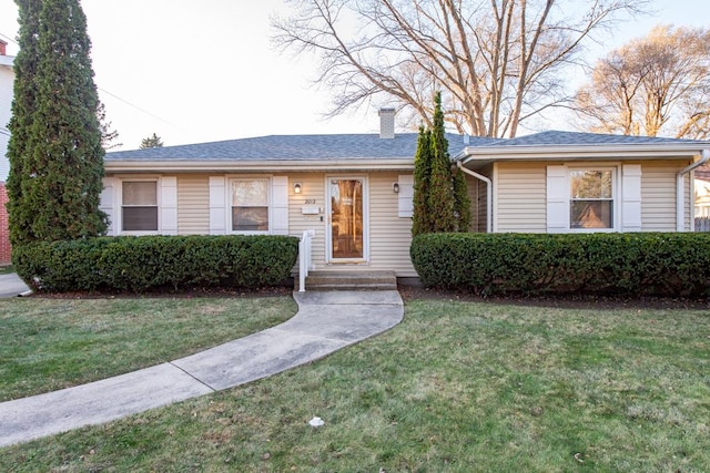 ranch-style home featuring a front yard