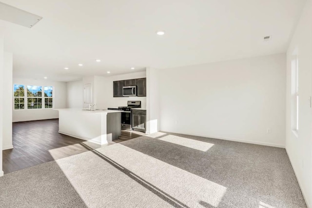 unfurnished living room featuring dark hardwood / wood-style floors and sink