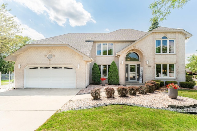 view of front facade with a garage and a front lawn