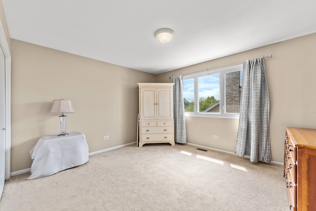 bedroom featuring light carpet