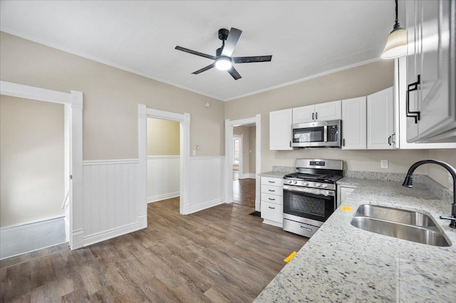 kitchen featuring pendant lighting, light stone countertops, sink, and appliances with stainless steel finishes