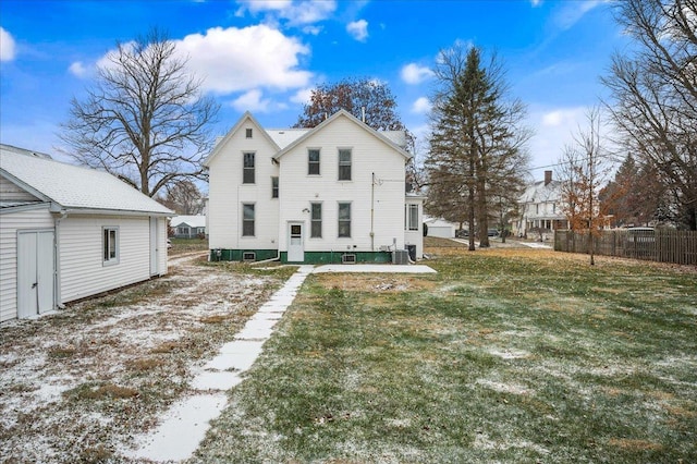 rear view of property featuring cooling unit and a yard