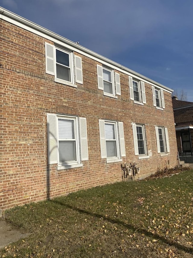 view of side of home featuring a yard