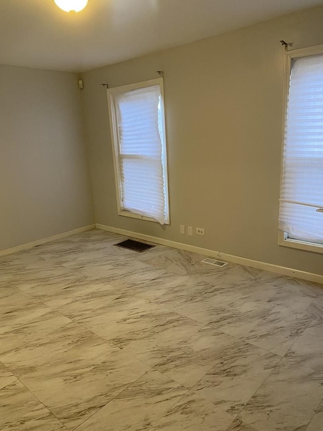 spare room featuring plenty of natural light