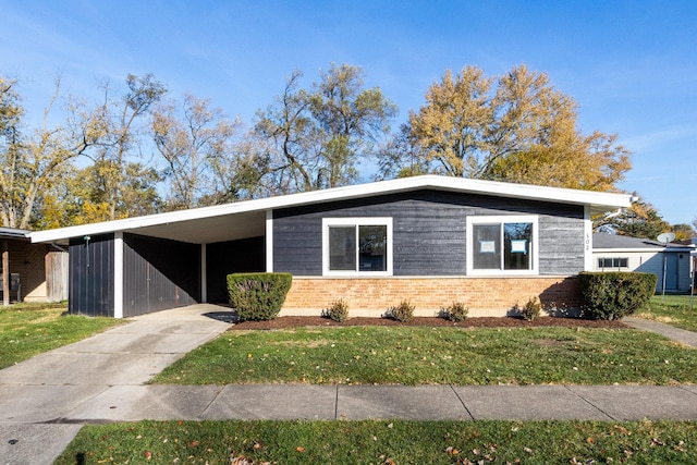 view of front facade with a front yard and a carport