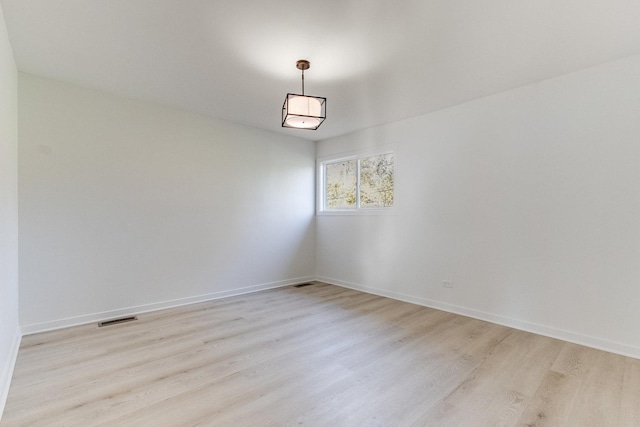 spare room with light hardwood / wood-style flooring