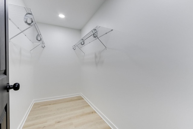 walk in closet featuring hardwood / wood-style flooring