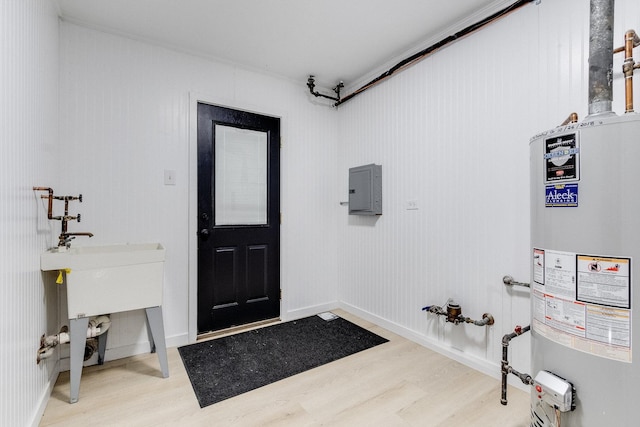 entryway featuring gas water heater, wood-type flooring, and electric panel