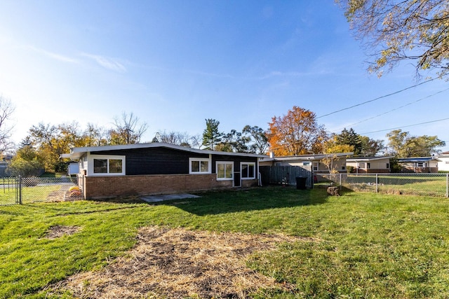 back of property featuring a yard