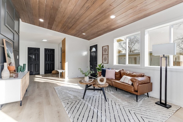 living room featuring light hardwood / wood-style flooring and wooden ceiling