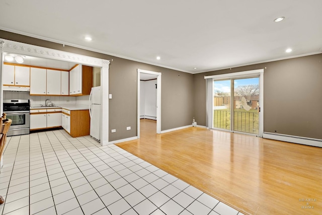 kitchen with white cabinetry, light hardwood / wood-style flooring, a baseboard heating unit, white fridge, and stainless steel range with gas stovetop