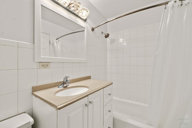 bathroom with vanity, shower / bath combination with curtain, and tile walls