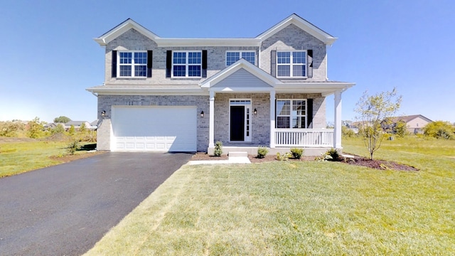 view of front of home featuring a front lawn, a porch, and a garage