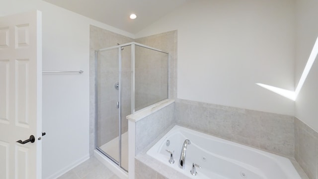 bathroom with shower with separate bathtub, vaulted ceiling, and tile patterned floors