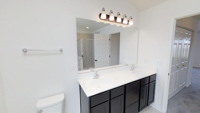 bathroom with vanity, a shower with shower door, and toilet